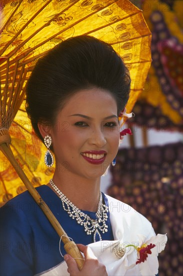 THAILAND, Chiang Mai, Portrait of young woman riding the beauty contest float in the Flower Festival parade