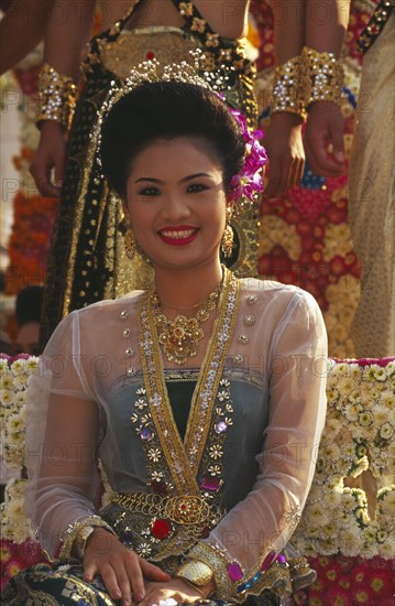THAILAND, Chiang Mai, Portrait of young woman riding the beauty contest float in the Flower Festival parade