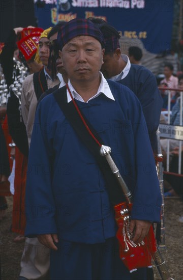 THAILAND, Chiang Mai Province, Samathi Mai, Kachin Manou. Kachin elder in line awaiting the start of a Manou dance