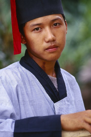 MYANMAR, Kachin State, Manhkring, Portrait of a Lisu man with Mahkhong marks on his neck in traditional Lisu attire of the Putao area