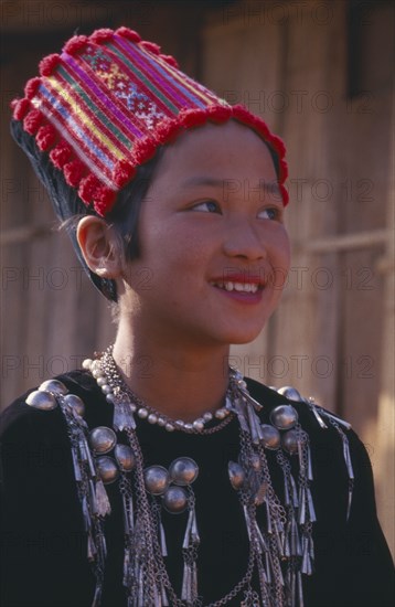 THAILAND, Chiang Mai Province, Muang Nga, Portrait of a Jinghpaw girl wearing traditional womans jacket and hat
