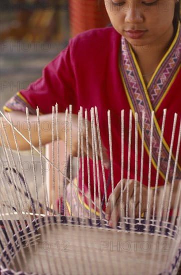 THAILAND, Chiang Mai, Thai woman making a basket