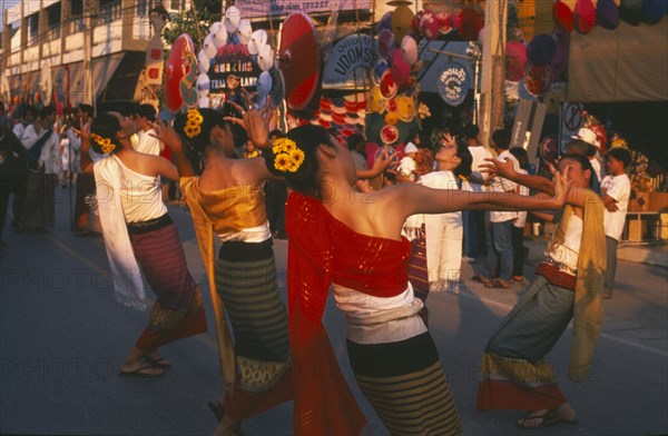 THAILAND, Chiang Mai, Baw Sang, Dancers in traditional northern Thai attire performing traditional Thai dance at the Umbrella Festival