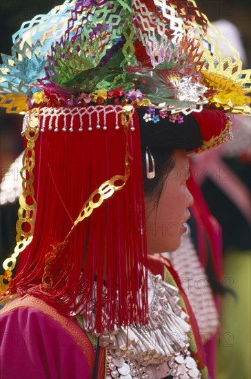 THAILAND, Chiang Rai Province, Huai Khrai, Portrait of a young Lisu woman in her New Year finery during a dance