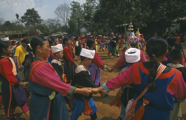 THAILAND, Chiang Rai Province, Huai Khrai, Lisu people dancing around a New Year tree to a banjo player