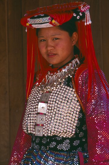 THAILAND, Chiang Rai Province, Doi Lan, Young Lisu woman in her New Year finery prior to going to a New Year dance