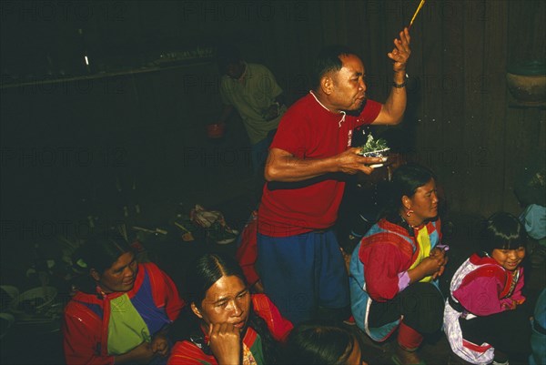 THAILAND, Chiang Rai Province, Doi Lan, New Year. Shaman performing ceremony to cure villagers afflictions