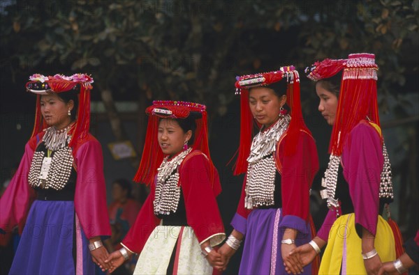 THAILAND, Chiang Rai Province, Huai Khrai, Young Lisu women dancing in their New Year finery