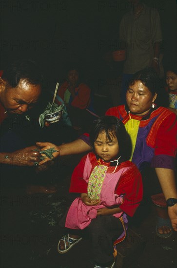 THAILAND, Chiang Rai Province, Doi Lan, New Year. Lisu Shaman performing ceremony to cure villages afflictions