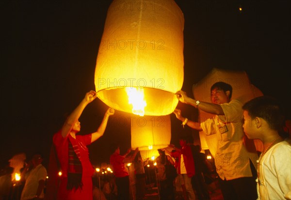 THAILAND, Chiang Mai, Mae Jo San Sai District, Loi Krathong Festival aka Yi Peng. People launching hot air balloons into the night sky