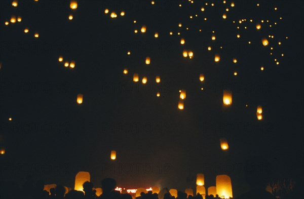 THAILAND, Chiang Mai, San Sai District, Loi Krathong Festival aka Yi Peng. People launching hot air balloons into the night sky