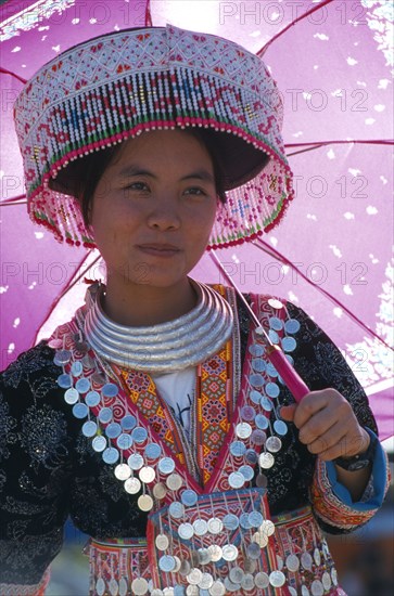THAILAND, Chiang Mai, Hmong New Year. Young white Hmong woman in her New Year finery