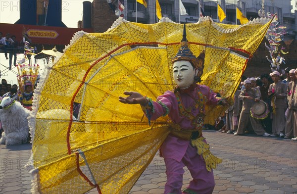 THAILAND, Chiang Mai, Shan Poi San Long. Crystal Children ceremony dancer with large yellow fan costume