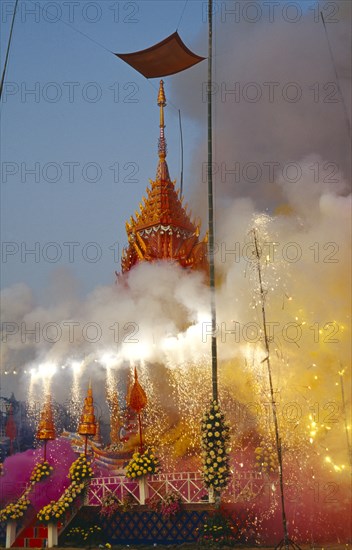 THAILAND, Chiang Mai, Revered monks funeral with smoking mythical elephant swan funeral pyre on the cremation grounds