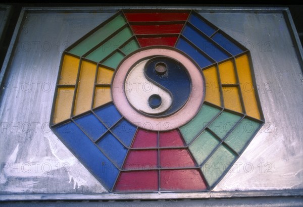 THAILAND, Chiang Mai, Yin Yang symbol above shop house on Loi Kroa Road