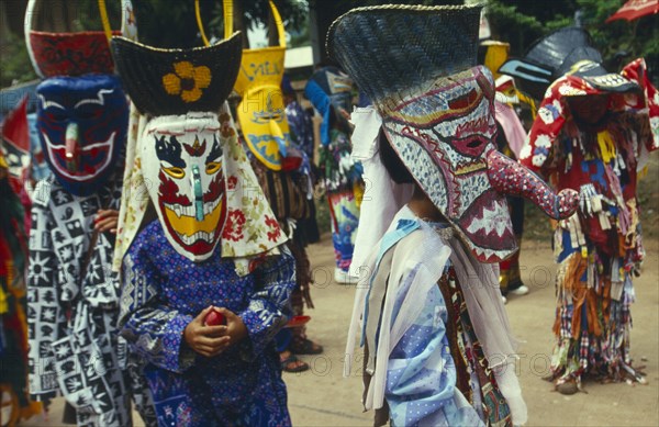 THAILAND, Loei Province, Dan Sai, Phi Ta Khon or Spirit Festival. Group of spirits in costume and masks at Wat Phon Chai