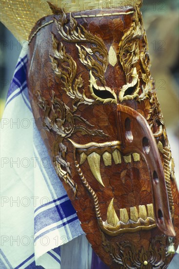 THAILAND, Loei Province, Dan Sai, Phi Ta Khon or Spirit Festival. Person wearing elaborate spirit mask