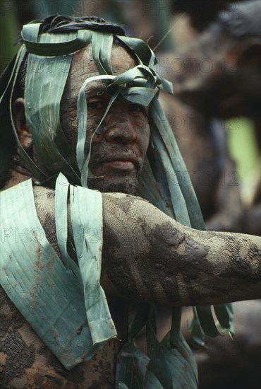 THAILAND, Loei Province, Dan Sai, Phi Ta Khon or Spirit Festival. Mud man covered in a layer of mud and leaves