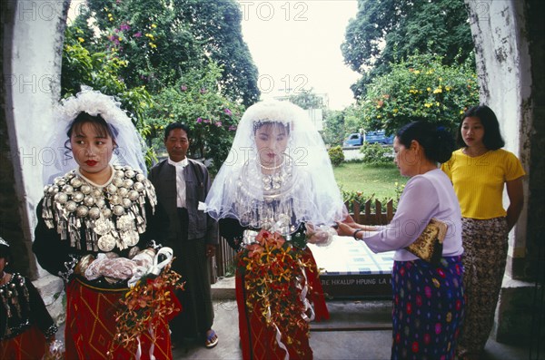 MYANMAR, Kachin State, Myitkyina, Jinghpaw wedding with Bride and bridesmaid entering the Geis memorial church