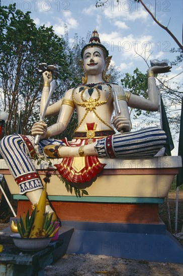 THAILAND, Chiang Mai, Wat Bahn Pueng Fang, Statue of Siva holding trident conch shell sword and discus