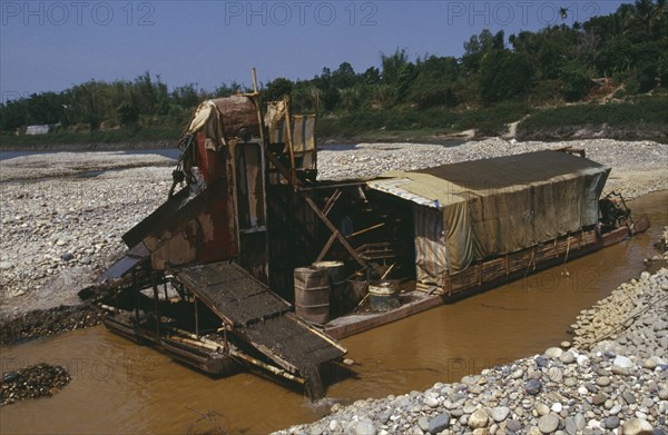 MYANMAR, Kachin State, Manhkring, Gold dredger on the upper Ayeyarwady River operated by prospectors from the Peoples Republic of China