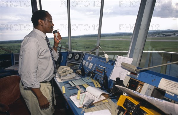 TANZANIA, Dar es Salaam, Man using radio in airport control tower in Dar es Salaam airport.