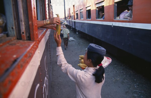 MYANMAR, Markets, Female vendor selling sweet corn to passengers on the Mandalay to Myitkyina train.