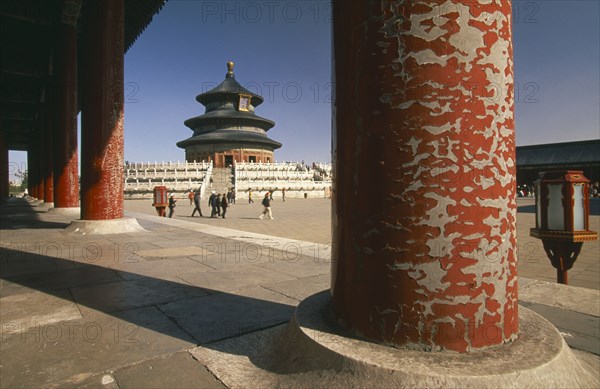 CHINA, Beijing, Temple of Heaven.  Hall of Prayer for Good Harvests through colonnade of pillars with peeling red paint.