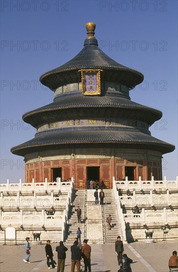CHINA, Beijing, Temple of Heaven.  Hall of Prayer for Good Harvests and Chinese visitors posing for photographs and on steps outside.