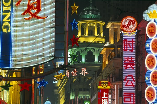 CHINA, Shanghai, Nanjing Road at night with illuminated neon signs.