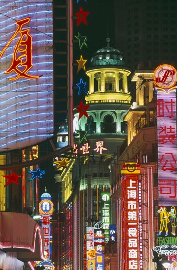 CHINA, Shanghai, Nanjing Road at night with illuminated neon signs.