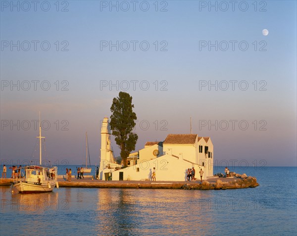 GREECE, Ionian Islands, Corfu, "Kanoni, south of Corfu Town.  Vlacherna Monastery.  Boat taking visitors to islet site of seventeenth century monastery."