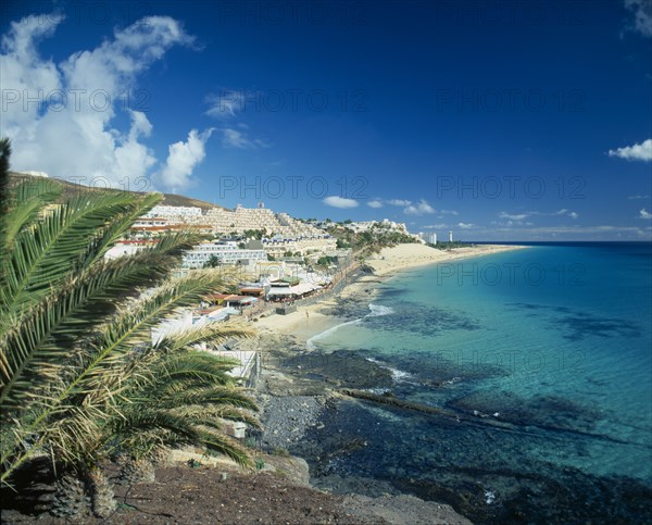 SPAIN, Canary Islands, Fuerteventura, Morro del Jable.  Coastal town with hotels and apartments stretching up hillside and overlooking the sea.