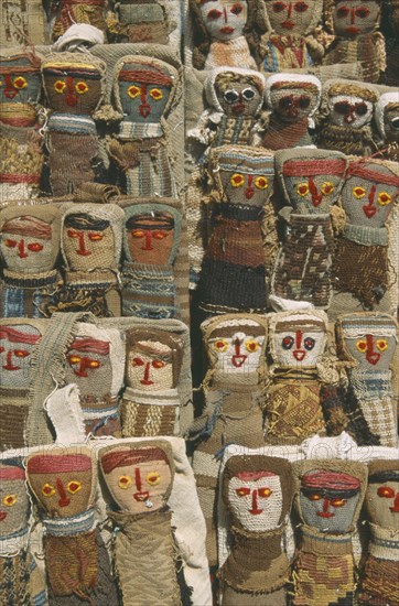 ECUADOR, Imbabura, Otavalo, Textile dolls on sale in craft market.