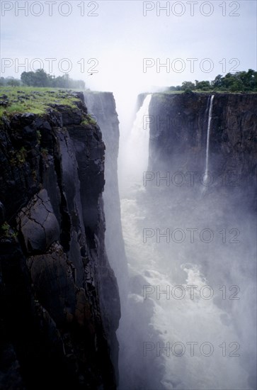 ZIMBABWE, Zambezi River, Victoria Falls, Waterfall plummeting over 355ft sheer cliff face in to a narrow chasm.