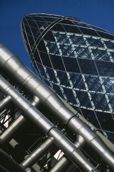 ENGLAND , London, Close cropped angled view of the Swiss Re Tower with other architecture in front