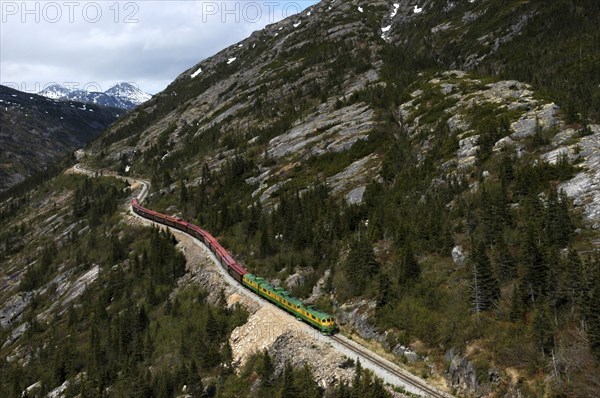 USA, Alaska, Skagway, White Pass and Yukon Railway travelling along a mountainside