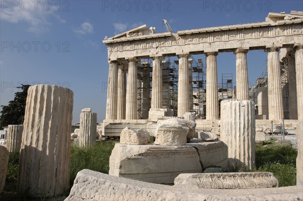 GREECE, Athens, Acropolis. View of the ruined Parthenon with smaller sections of columns in the foreground