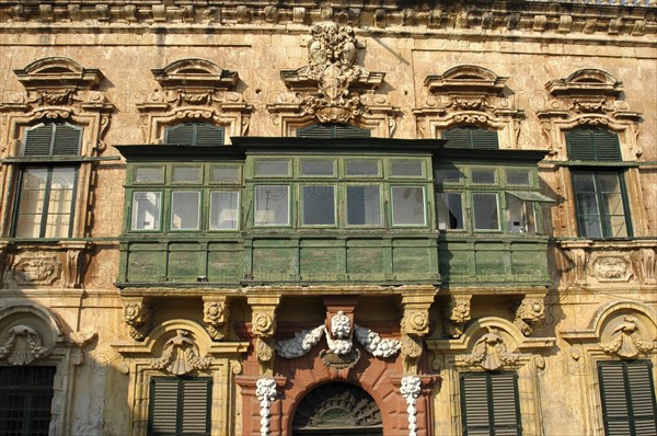 MALTA, Valletta , Section of building facade with green painted enclosed balcony