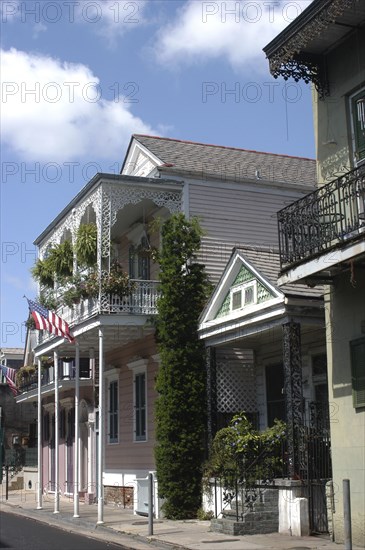 USA, Louisiana, New Orleans, French Quarter. Typical architecture with ironwork balconies and American flag