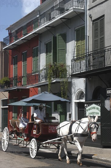 USA, Louisiana, New Orleans, French Quarter. Horse drawn carriage with passenger