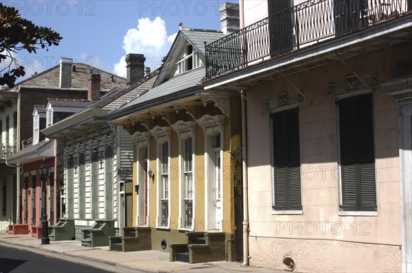 USA, Louisiana, New Orleans, French Quarter. View along pastel coloured architecture with shuttered windows