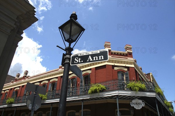 USA, Louisiana, New Orleans, French Quarter. Lamp post and street sign on Rue St Anne with typical architecture behind