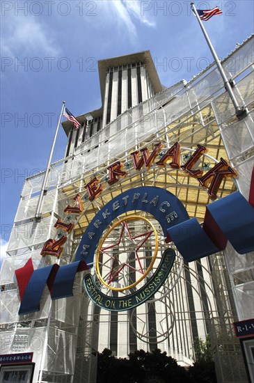 USA, Louisiana, New Orleans, Angled view looking up athe Riverwalk Marketplace entrance sign with highrise buildings behind