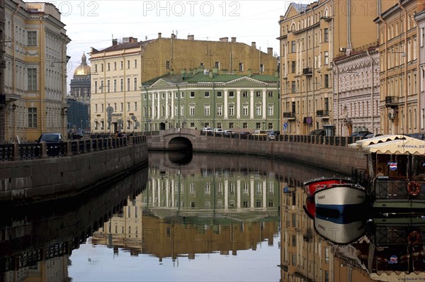 RUSSIA, St Petersburg, View along canal with small boats and ferry moored to one side