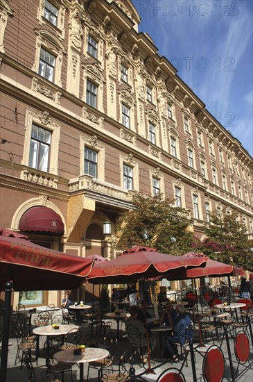 RUSSIA, St Petersburg, Street cafe with tables and chairs under large red umbrellas