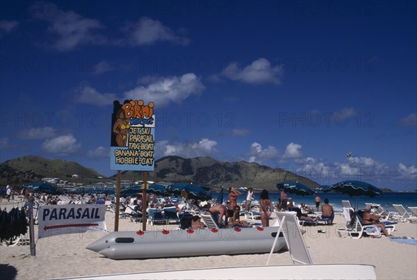 WEST INDIES, French Antilles, St Martin, Orient beach with people sunbathing on loungers