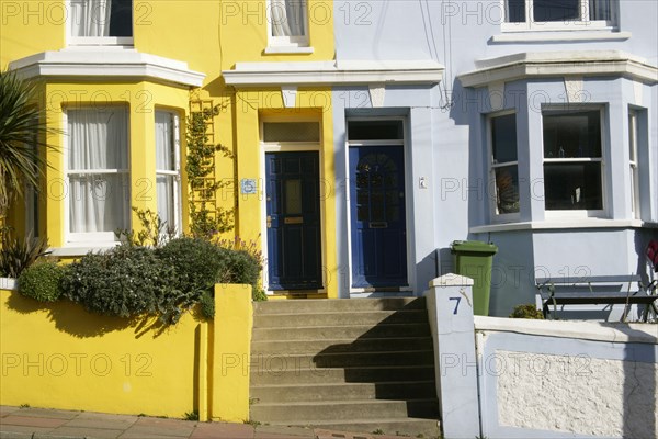 ENGLAND, East Sussex, Brighton, Brightly coloured terraced houses in Kemp Town