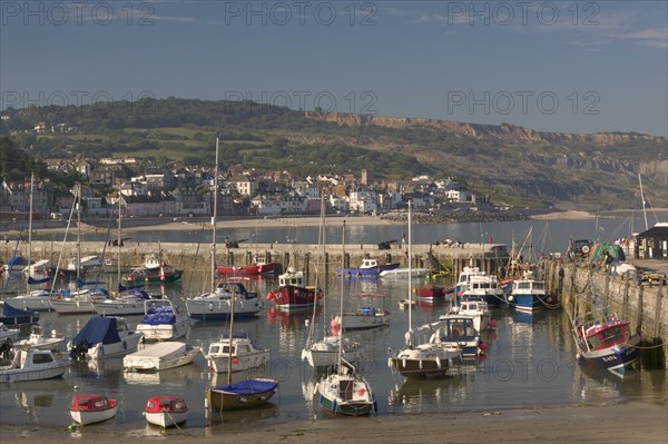 ENGLAND, Dorset, Lyme Regis, View of the town across the harbour from The Cobb.