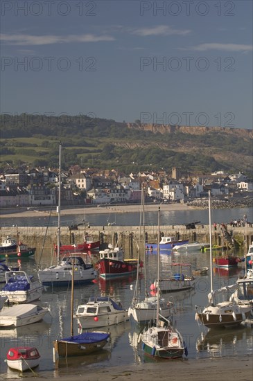 ENGLAND, Dorset, Lyme Regis, View of the town across the harbour from The Cobb.